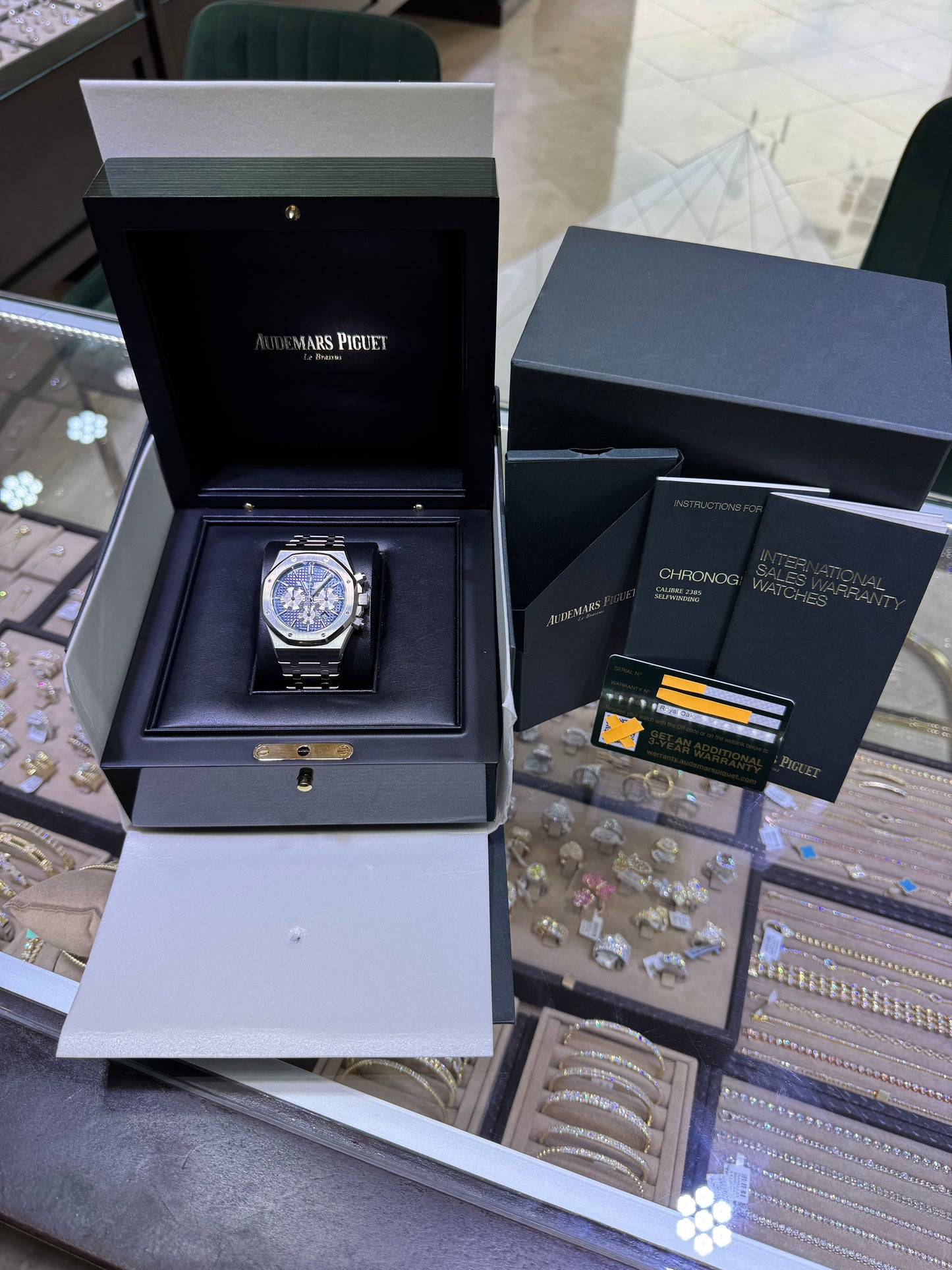 Audemars Piguet Royal Oak Chronograph 26331ST blue dial stainless steel watch with box, papers, warranty card, and accessories.