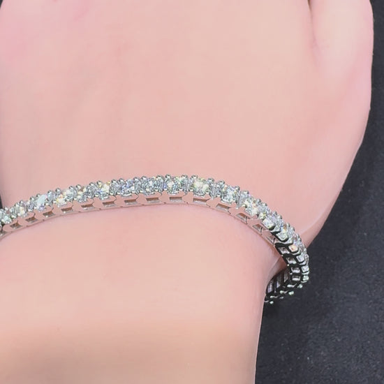 Close up video of white gold round diamond tennis bracelet worn on wrist showing diamond sparkle