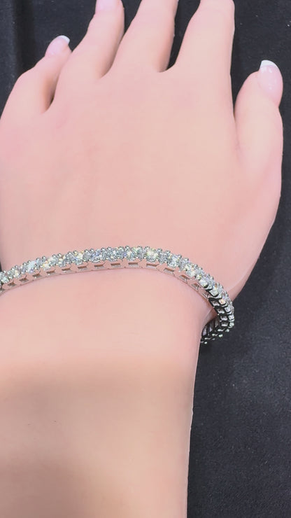 Close up video of white gold round diamond tennis bracelet worn on wrist showing diamond sparkle