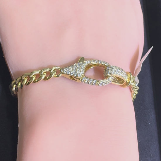 Video of a 14KT yellow gold Cuban link bracelet featuring a diamond lobster clasp worn on wrist highlighting natural diamond sparkle and polished gold links