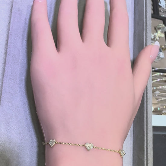 video of 14k yellow gold diamond heart station bracelet worn on wrist showing sparkle and movement in Huntington Beach Orange County