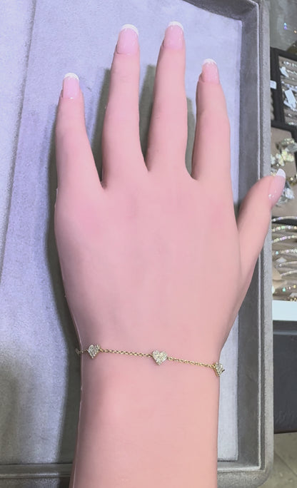 video of 14k yellow gold diamond heart station bracelet worn on wrist showing sparkle and movement in Huntington Beach Orange County