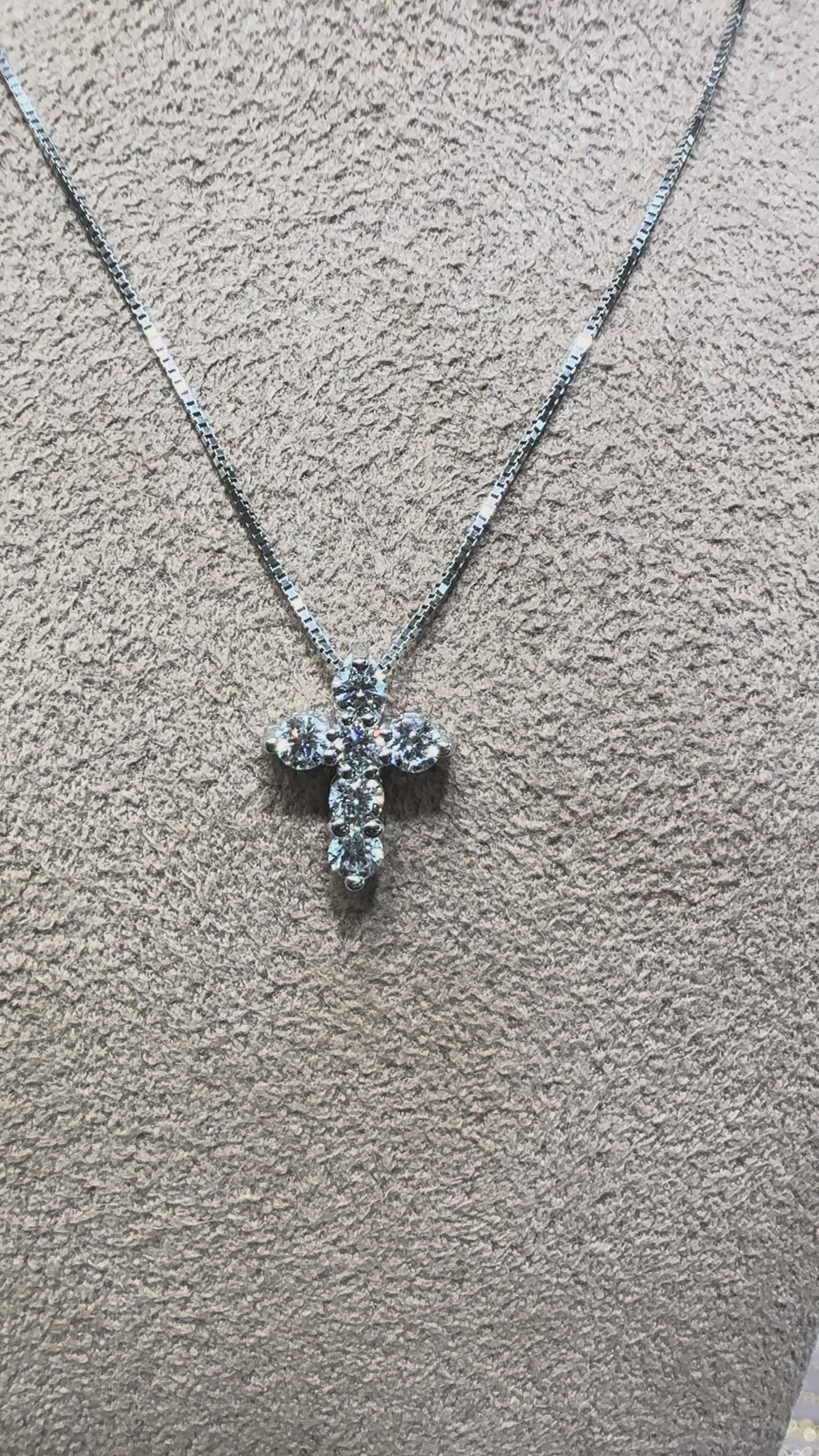 Video of a 14K gold diamond cross necklace featuring 0.46 carats total weight of round brilliant diamonds on a delicate chain, available in white gold, yellow gold, and rose gold.