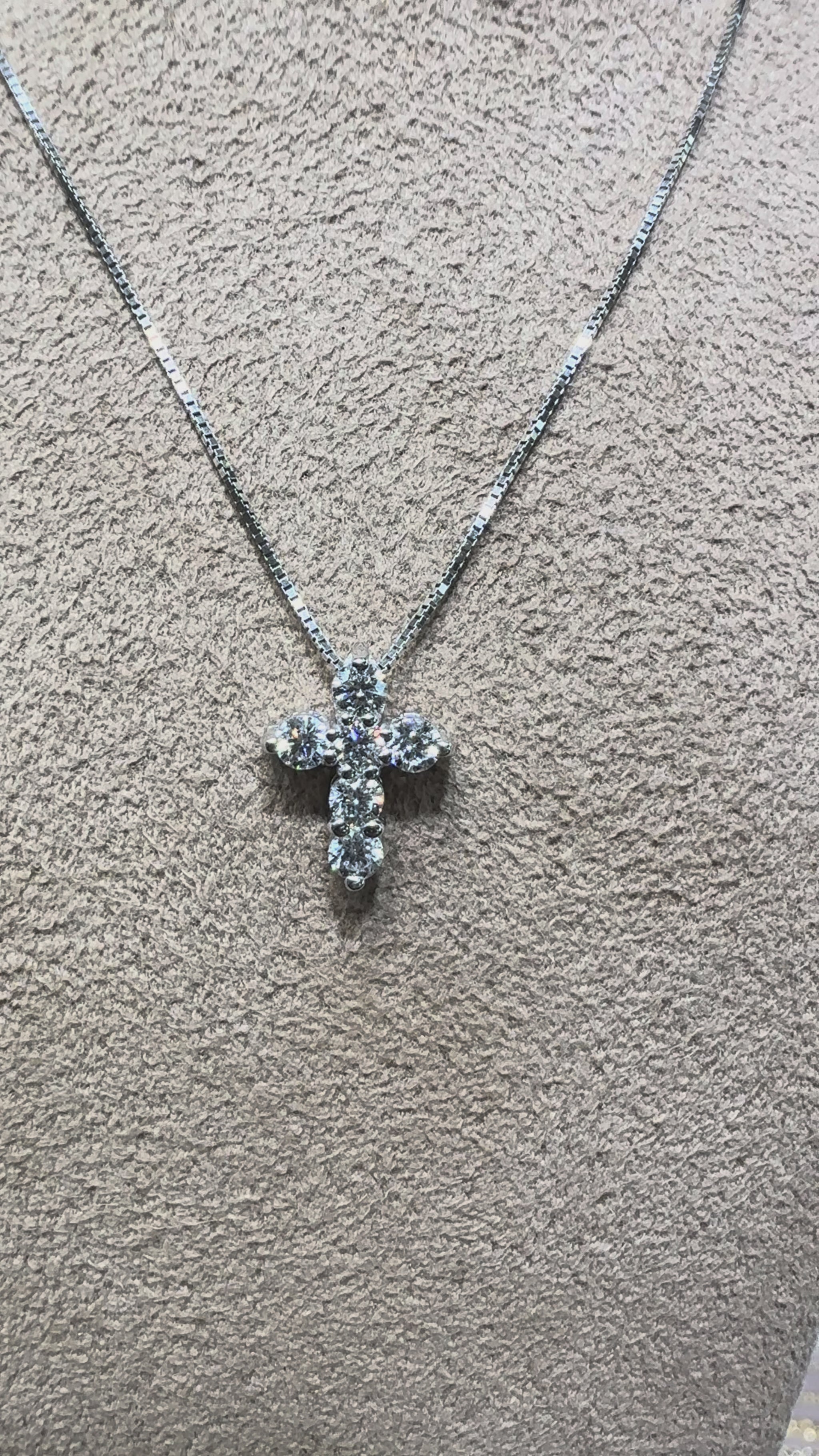 Video of a 14K gold diamond cross necklace featuring 0.46 carats total weight of round brilliant diamonds on a delicate chain, available in white gold, yellow gold, and rose gold.
