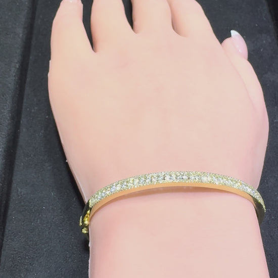 14K gold three row round brilliant diamond bangle bracelet showcasing center row with larger diamonds and smaller top and bottom rows available in Huntington Beach Orange County