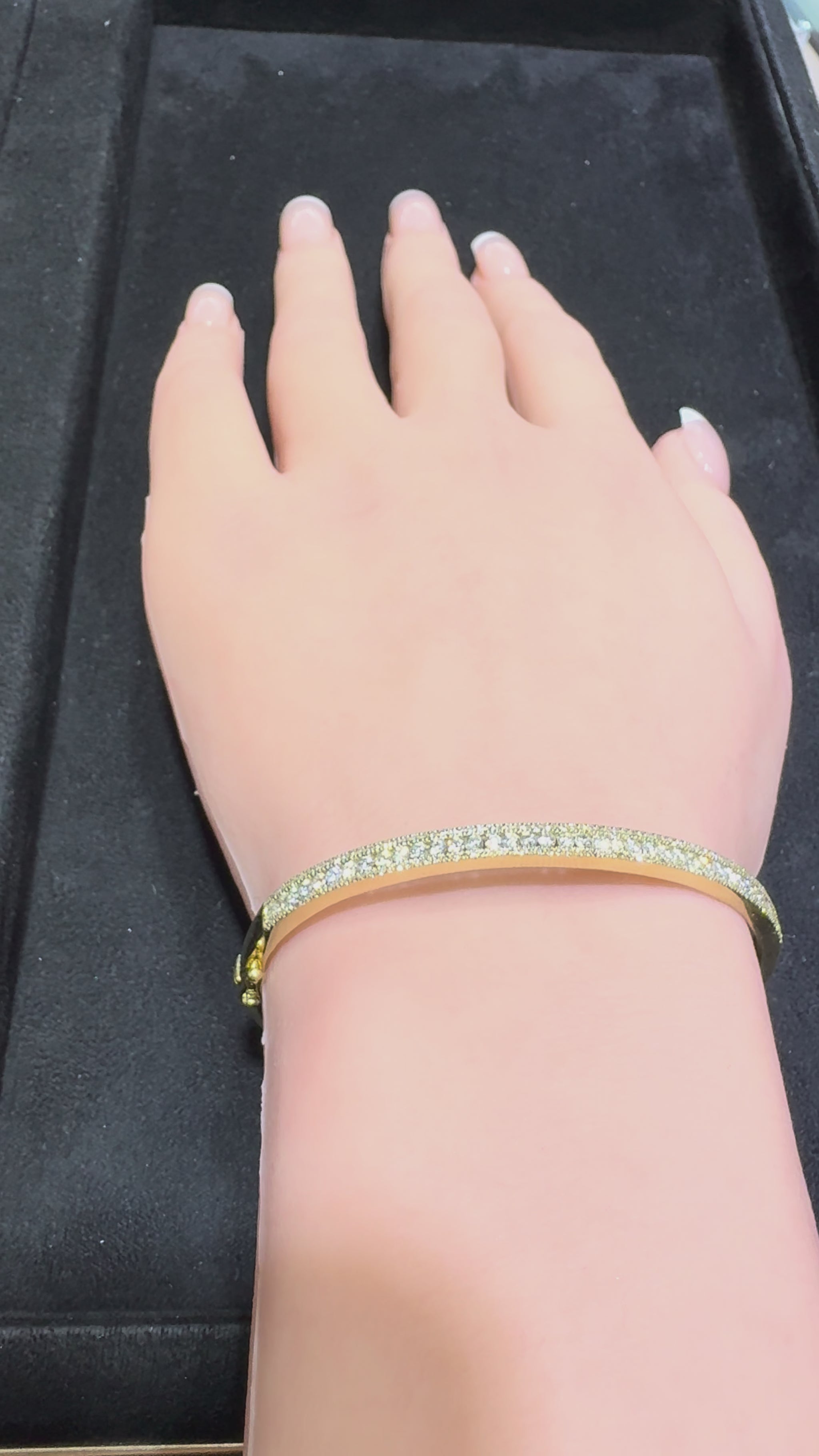 14K gold three row round brilliant diamond bangle bracelet showcasing center row with larger diamonds and smaller top and bottom rows available in Huntington Beach Orange County