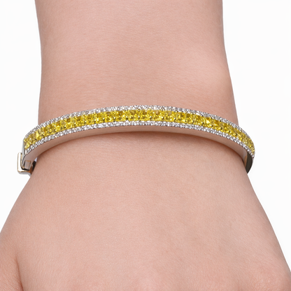 14K white gold bangle bracelet with yellow center diamonds and white diamond halo worn on wrist Isabella’s Fine Jewelry Huntington Beach Orange County