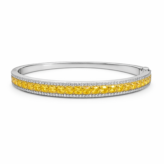 14K white gold bangle bracelet with center row of yellow diamonds and white diamond pave accents on a clean white background for product display