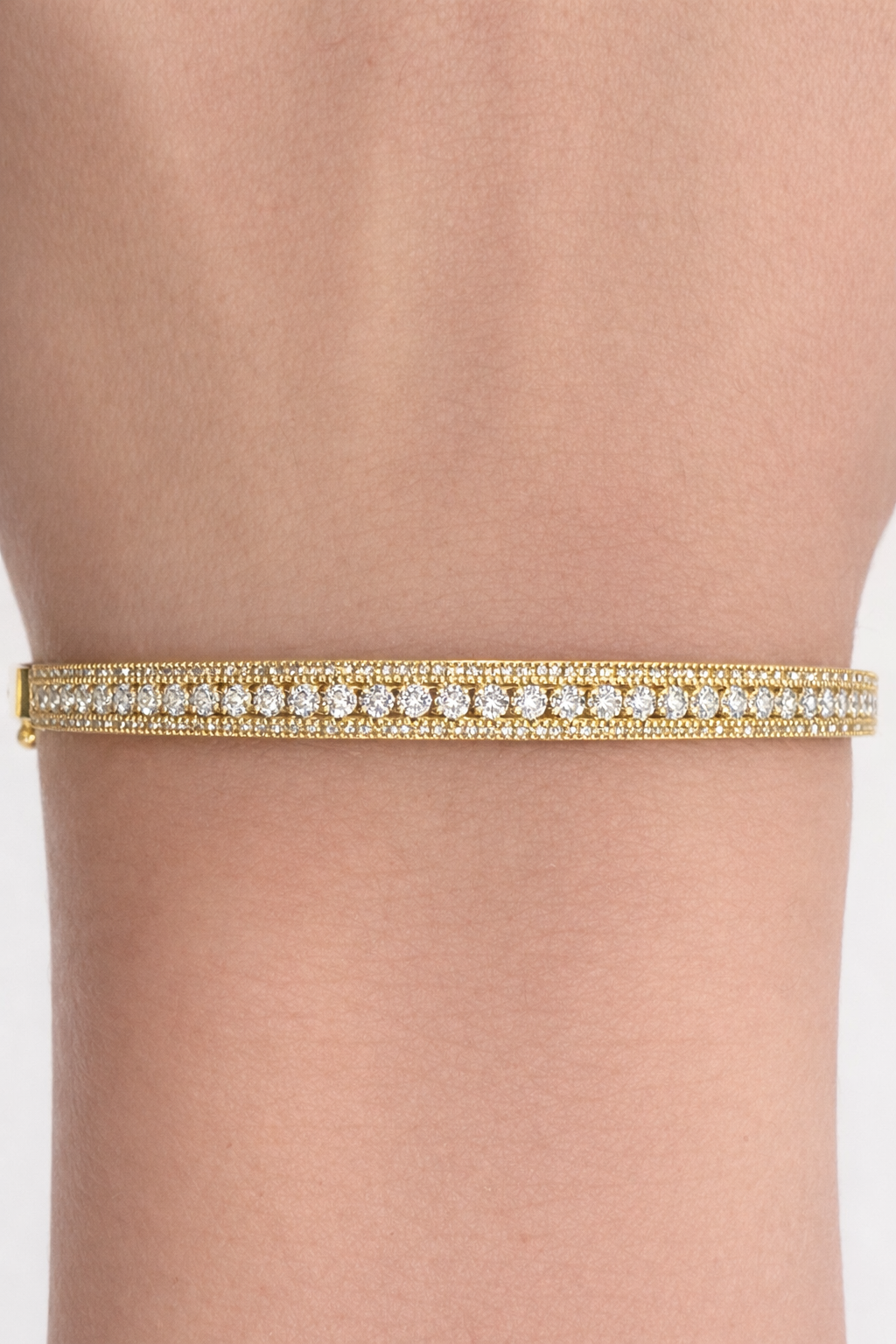 Yellow gold three row diamond bangle bracelet worn on wrist Huntington Beach Orange County